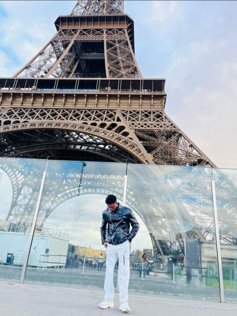 Leke Ariyo in Paris, France, looking down as he poses for a photograph